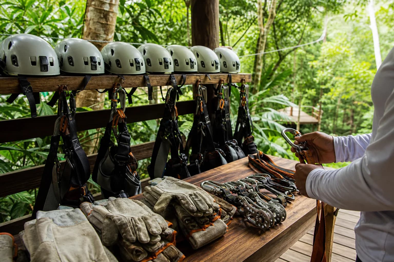 Helmets, harnesses, gloves, and zipline equipment prepared for guests