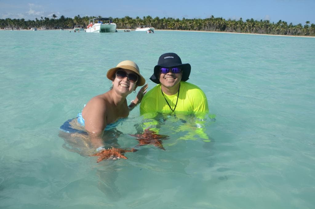 Travelers enjoying clear Caribbean water during an island excursion