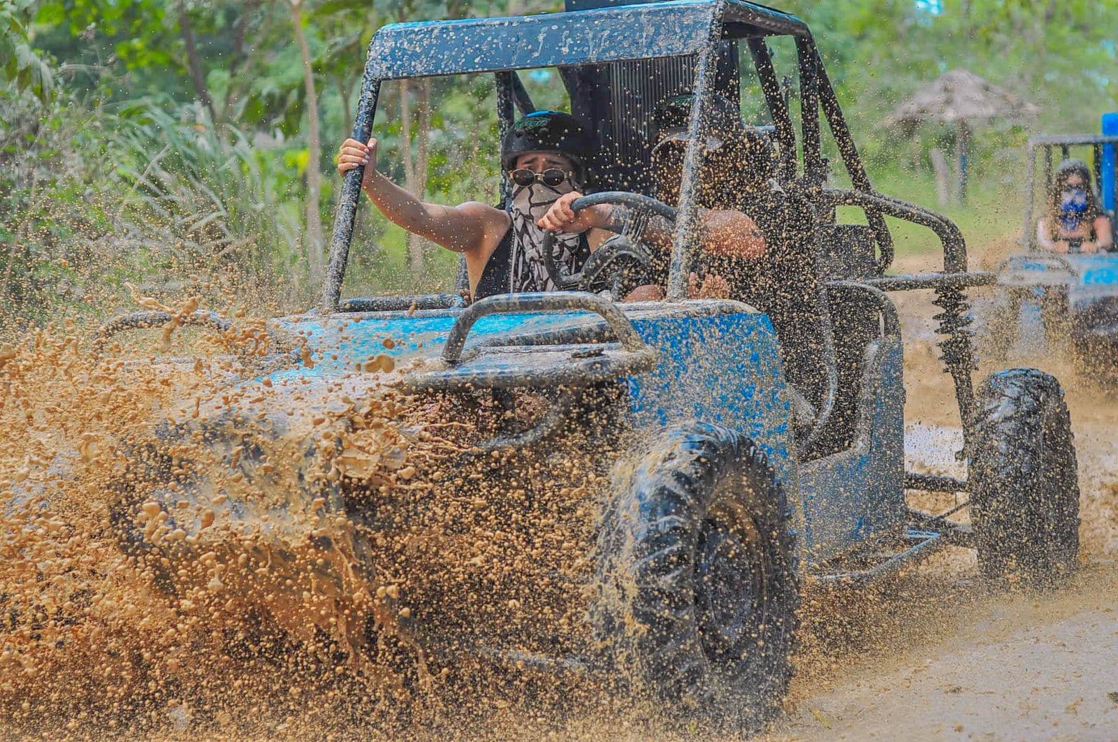 Buggy tour Punta Cana splashing through a muddy trail